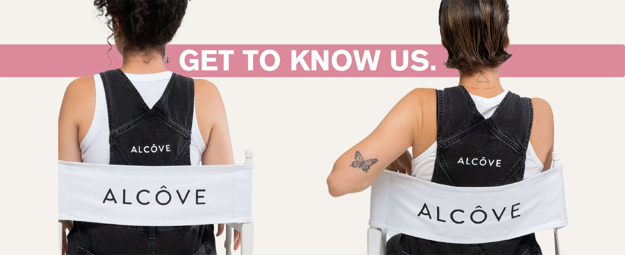 Two people wearing black Alcove back braces with a pink banner above them.