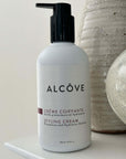 Picture of a Bottle of Alcove Hair Styling Cream 250 ml with a bathroom background